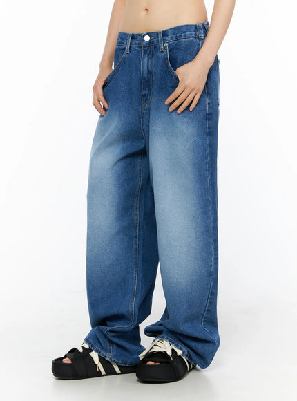 Easton Washed Wide Leg Jeans CU530 Dark blue side-view on model showing wide leg silhouette, faded wash gradient, deep front pocket, and pooled hem over black platform sandals