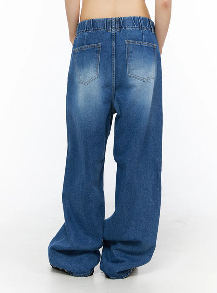 Easton Washed Wide Leg Jeans CU530 Dark blue back view on model showing elasticated waistband, two back pockets, wide leg silhouette with pooled hem, faded wash finish