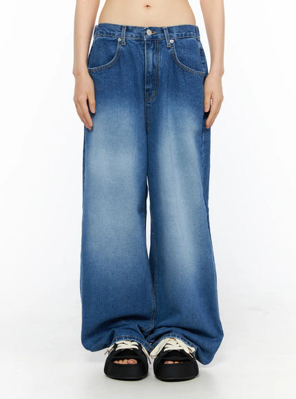 Easton Washed Wide Leg Jeans CU530 Dark blue front view on model arms at sides showing five-pocket detail, low-rise waistband, faded gradient wash, and extra-wide leg pooling over sandals