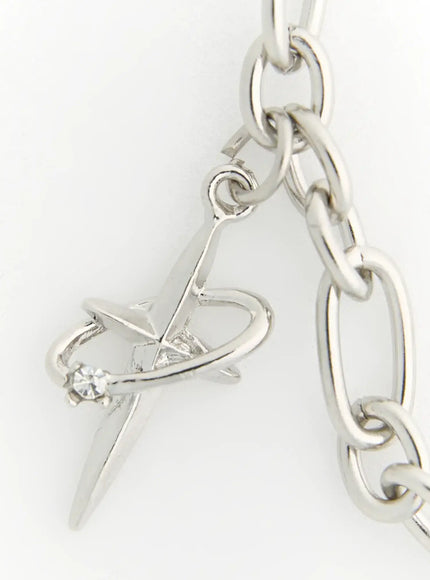 Eden Key Necklace IL522 Silver close-up detail of dagger and heart charm with crystal accent on oval link chain