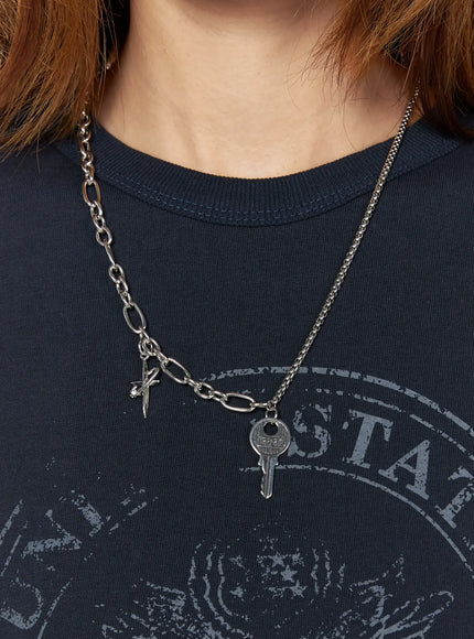 Eden Key Necklace IL522 Silver on-model front view styled on navy crewneck showing full asymmetric mixed chain with key and dagger pendants