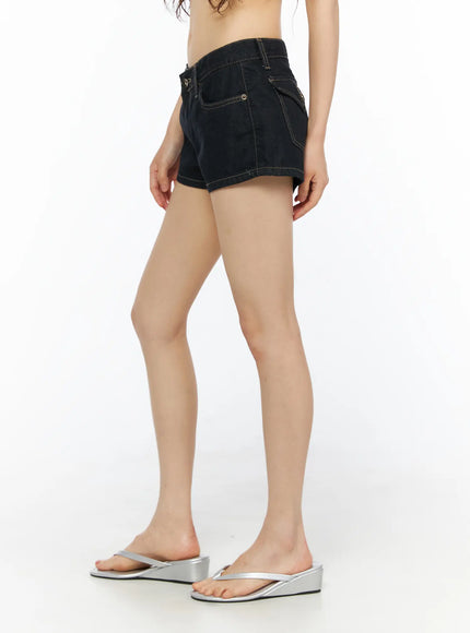 Eimi Low-Rise Denim Shorts CU530 Dark blue side shot on model showing low-rise fit, side pocket with snap button detail and contrast golden stitching