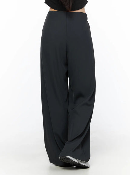 Elastic Waist Relaxed Pants CL524 Black back crop shot on model showing rear waistband, center seam, and pooling hem with silver sneakers