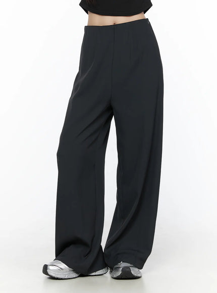 Elastic Waist Relaxed Pants CL524 Black front shot on model from waist to hem showing wide-leg drape, center crease, and silver sneakers