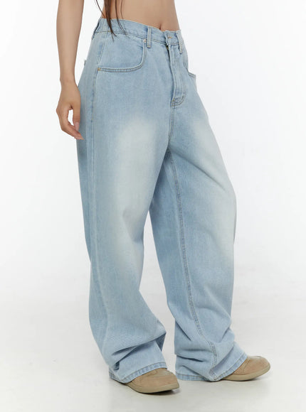 Elunie Washed Wide Leg Jeans CL507 light blue side view on model showing wide-leg silhouette, faded wash, and pooling hem with beige sneakers