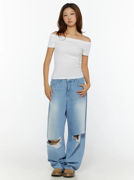 Elvin Low Rise Baggy Ripped Jeans CL515 Light blue full-body front shot on model with white off-shoulder top hands at sides showing wide leg silhouette