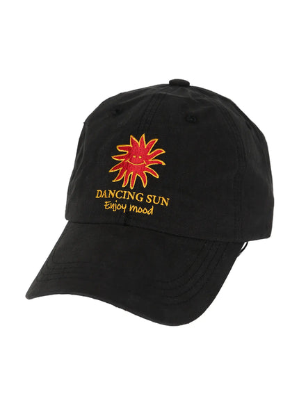 Embroidered Sun Logo Cap IL515 Black three-quarter hanger shot showing Dancing Sun Enjoy mood embroidery on structured six-panel black cap