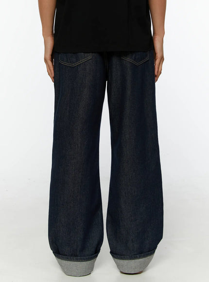 Emil Dark-Wash Straight-Leg Jeans IL515 Dark blue back close-up on model showing dual back pockets with contrast stitching and wide rolled cuff hem detail