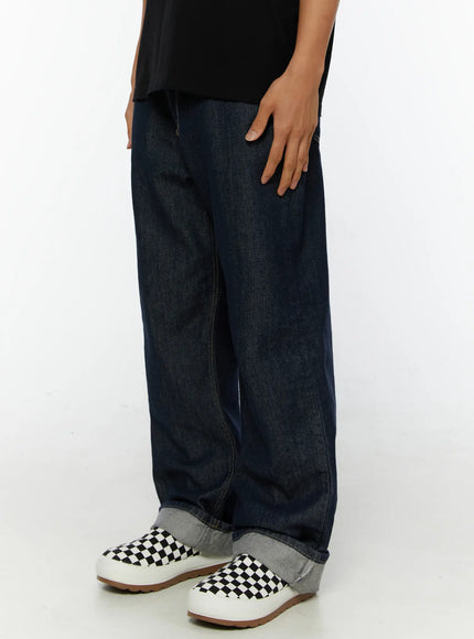 Emil Dark-Wash Straight-Leg Jeans IL515 Dark blue side shot on model hand in pocket showing wide-leg denim with rolled cuff and loafer styling