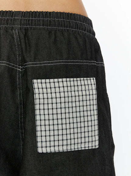 Esmé Gingham Cuff Jean Shorts CL515 Black close-up detail of back gingham patch pocket on black denim with white contrast stitching