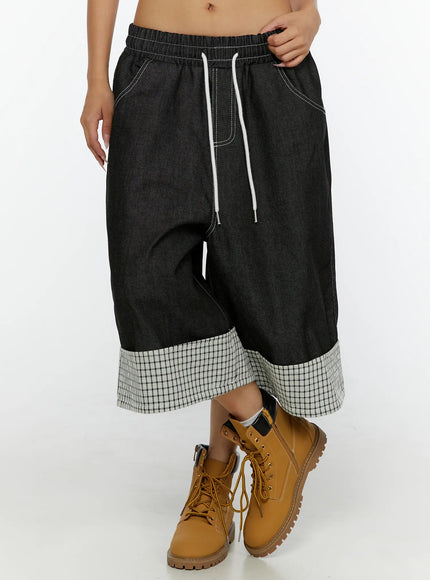 Esmé Gingham Cuff Jean Shorts CL515 Black front three-quarter view on model showing drop-crotch silhouette drawstring and gingham cuff