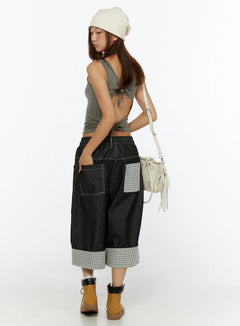 LEWKIN Esmé Gingham Cuff Jean Shorts CL515 Black side-rear view on model wearing beanie and tan boots with crossbody bag