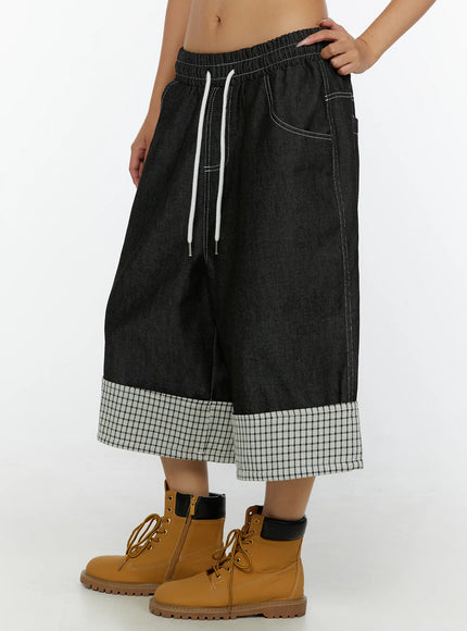 Esmé Gingham Cuff Jean Shorts CL515 Black side view on model hand on hip showing drawstring waist and gingham cuffed hem