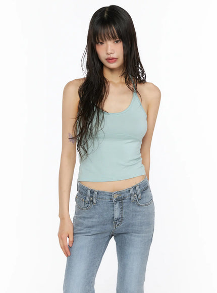 Essential Halter Tank CU530 mint front shot on model looking forward, cropped scoop-neck halter with crossback strap and bust seam detail styled with jeans