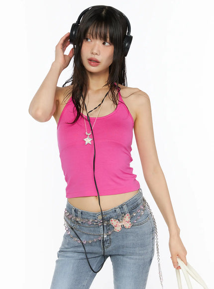 Essential Halter Tank CU530 Pink upper-body front shot on model wearing headphones and star necklace, cropped ribbed halter with halter straps and seam detail