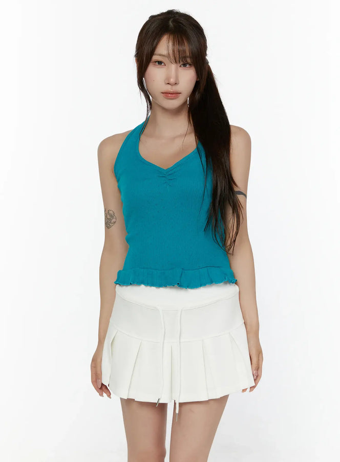 LEWKIN Eyelet Frill Halter Sleeveless Top CL507 Blue front view on model standing straight wearing white pleated mini skirt ribbed knit halter with ruffle hem