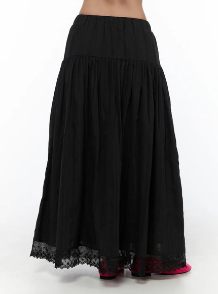 Eyelet Lace Flared Long Skirt CL510 Black back hanger shot displaying full gathered volume, elastic waistband, and floral eyelet lace trim along hem