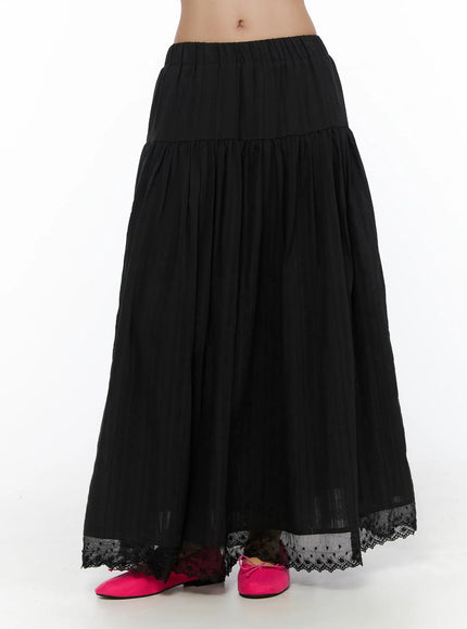 LEWKIN Eyelet Lace Flared Long Skirt CL510 Black front hanger shot showing tiered A-line silhouette, elastic waistband, and floral eyelet lace hem trim