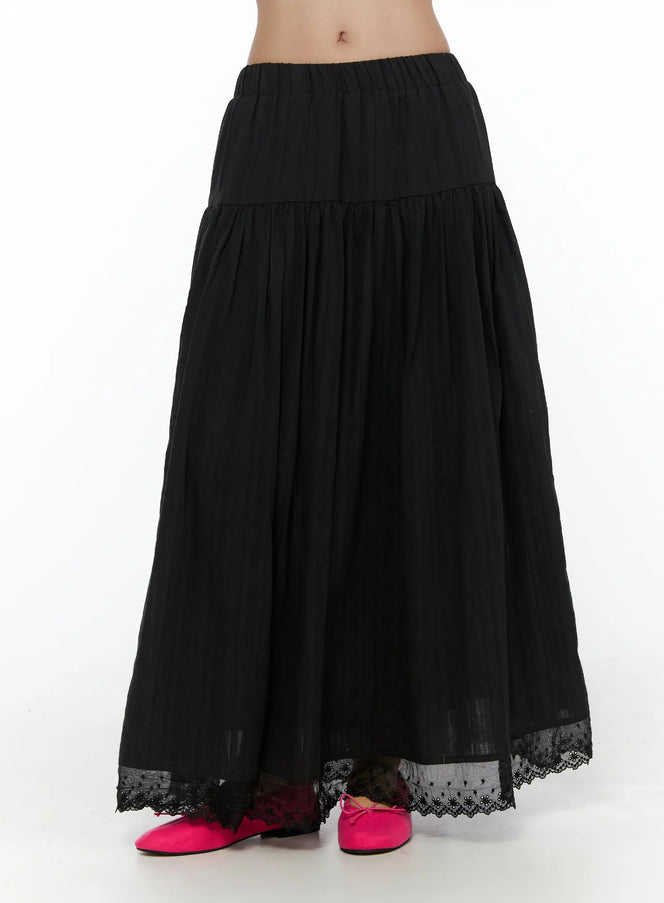 LEWKIN Eyelet Lace Flared Long Skirt CL510 Black front hanger shot showing tiered A-line silhouette, elastic waistband, and floral eyelet lace hem trim