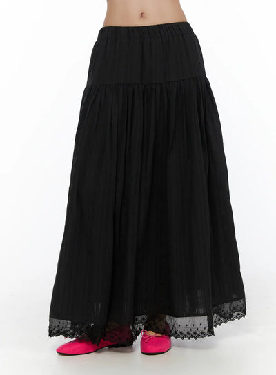 LEWKIN Eyelet Lace Flared Long Skirt CL510 Black front hanger shot showing tiered A-line silhouette, elastic waistband, and floral eyelet lace hem trim