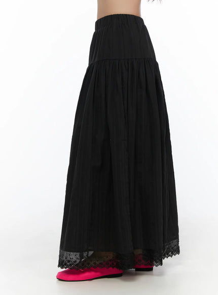 Eyelet Lace Flared Long Skirt CL510 Black side hanger shot highlighting gathered tiered skirt body, elastic waistband, and eyelet lace border at hem