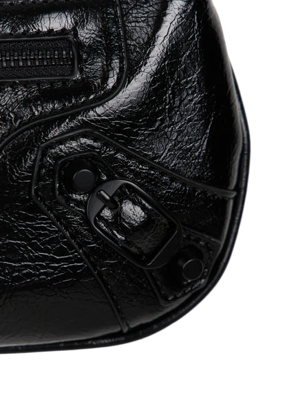 Faux Leather Crossbody CL517 Black close-up detail bottom-right corner showing matte buckle hardware stud rivets and crinkled patent leather surface texture