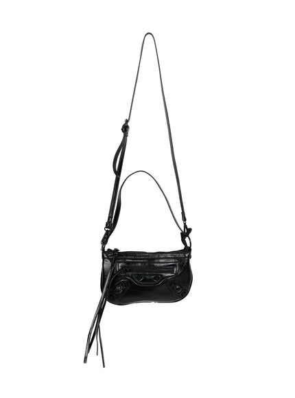 Faux Leather Crossbody CL517 Black full hanger shot with long adjustable crossbody strap knot detail front zip pockets stud accents and tassel fringe on white background