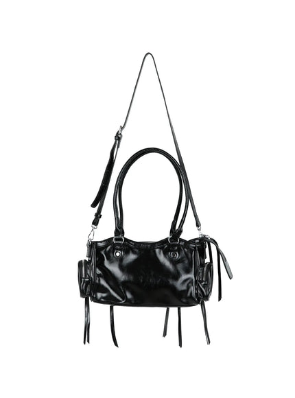 Faux Leather Shoulder Bag CL527 Black hanger back view with crossbody strap extended, smooth glossy faux leather back panel with side zip pouches and fringe tassels