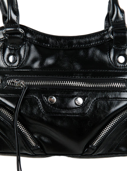 Faux Leather Shoulder Bag CL527 Black close-up detail of front zipper pocket, silver studs, glossy crinkled faux leather texture and diagonal zipper pockets