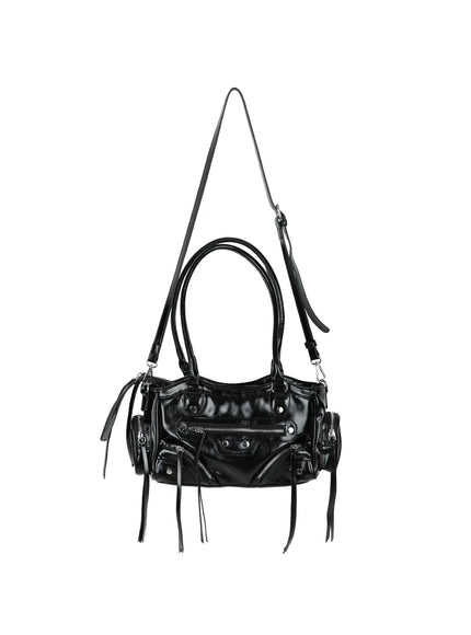 Faux Leather Shoulder Bag CL527 Black hanger front view with dual top handles and crossbody strap extended, multiple silver zippers and fringe tassels on glossy faux leather