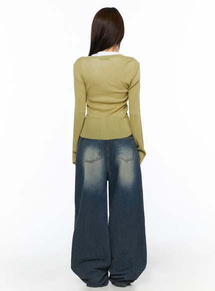 Fia Washed Baggy Jeans IL523 Dark blue full-body back shot on model in olive ribbed cardigan over white tee, showing back pockets and faded wide-leg hem pool