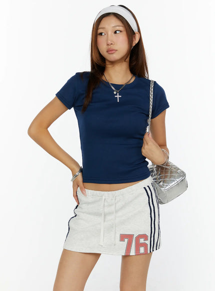 Fitted Crop Top CL515 Dark blue three-quarter front view on model size S/M looking aside hand on hip styled with silver bag and headband