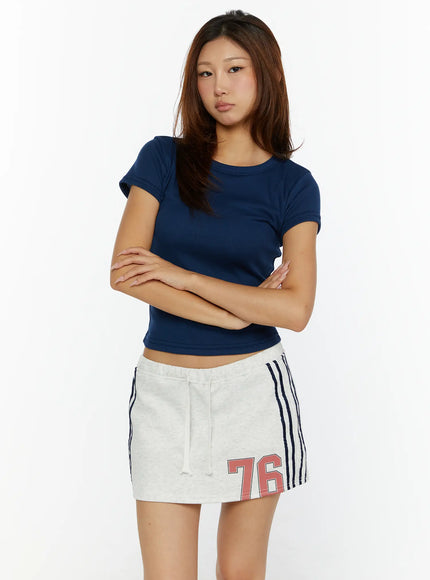 Fitted Crop Top CL515 Dark blue front view on model size S/M arms crossed showing round neckline ribbed texture and cropped hem