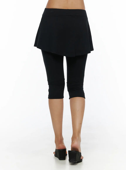 Flare Skort CL503 Black back shot on model showing rear skirt flare and cropped legging with ruched calf hem paired with wedge sandals