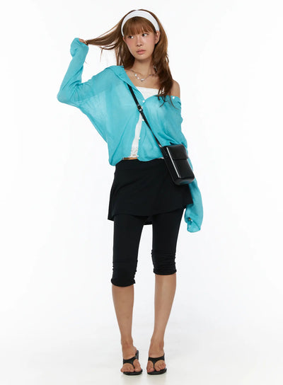 LEWKIN Flare Skort CL503 Black full-length front styling shot on model wearing teal cardigan and crossbody bag with black capri legging layer visible