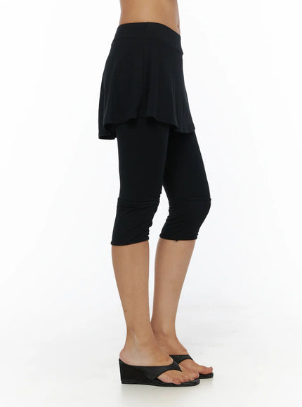 Flare Skort CL503 Black side shot on model showing flared skirt silhouette and capri legging layer with ruched hem detail at ankle
