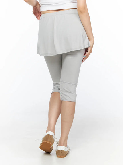 Flare Skort CL517 Light gray back view on model standing, showing flared skirt hem and capri legging fit with banded knee detail and ruched ankle cuffs
