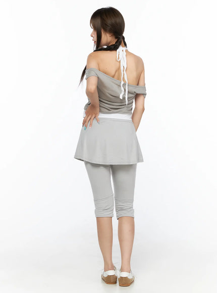 Flare Skort CL517 Light gray back view on model standing, showing full back of flared skirt overlay and capri legging fit, off-shoulder top with halter tie detail