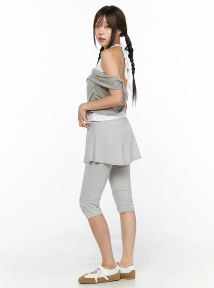 Flare Skort CL517 Light gray side view on model standing, showing skirt flare silhouette and capri legging length, styled with off-shoulder draped top and sneakers