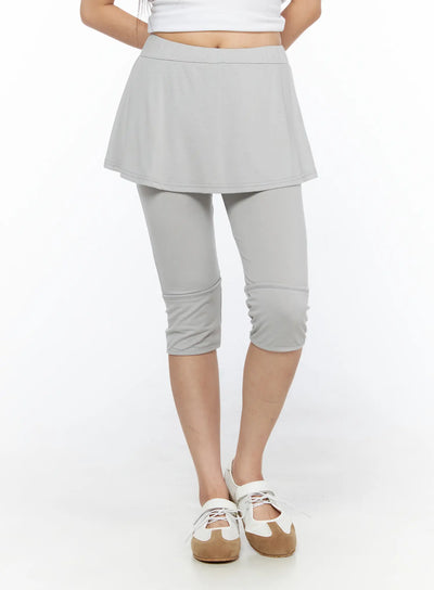 LEWKIN Flare Skort CL517 Light gray front close-up on model, S/M, cropped view showing flared mini skirt over capri leggings with banded hem, soft jersey fabric