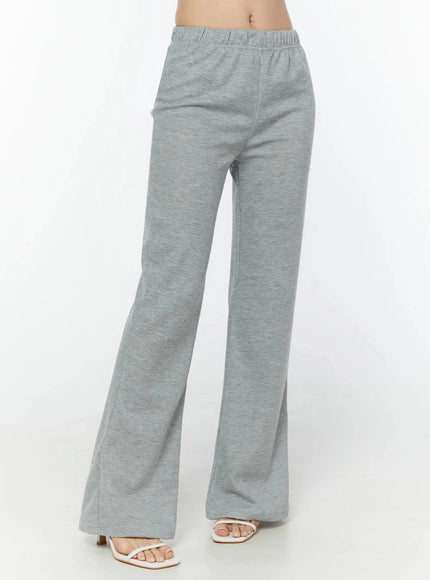 Flare Sweatpants IU524 Gray front cropped shot on model showing elastic waist center seam flared leg and heeled sandals angled view