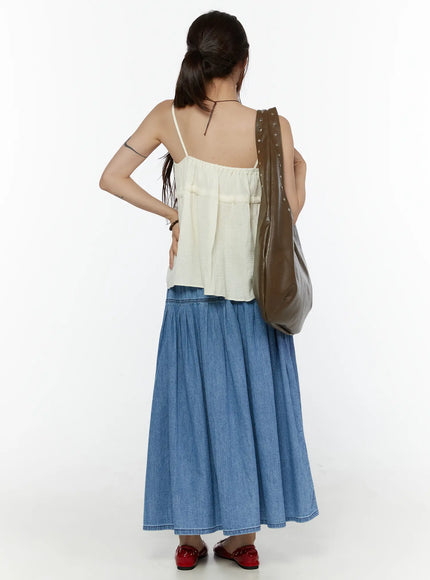Flared Denim Maxi Skirt CL508 Blue back full-length shot on model styled with cream camisole and olive studded shoulder bag