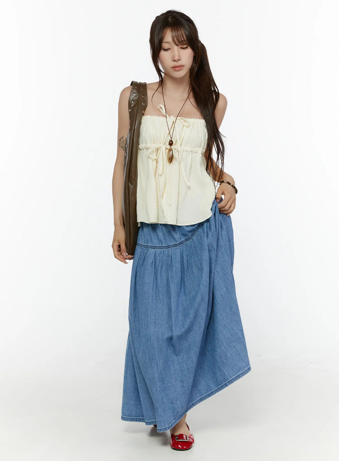 LEWKIN Flared Denim Maxi Skirt CL508 Blue full-length front shot on model styled with cream tube top and olive bag
