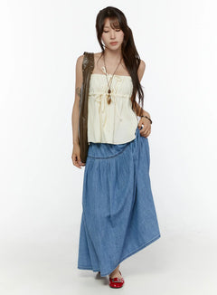 LEWKIN Flared Denim Maxi Skirt CL508 Blue full-length front shot on model styled with cream tube top and olive bag