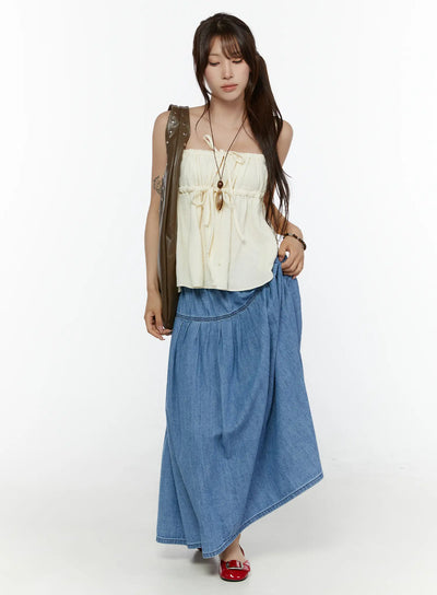LEWKIN Flared Denim Maxi Skirt CL508 Blue full-length front shot on model styled with cream tube top and olive bag