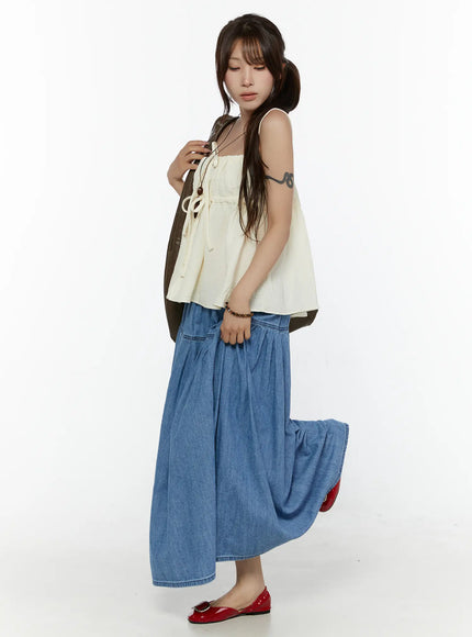 Flared Denim Maxi Skirt CL508 Blue side full-length shot on model lifting hem to show skirt volume styled with red flats