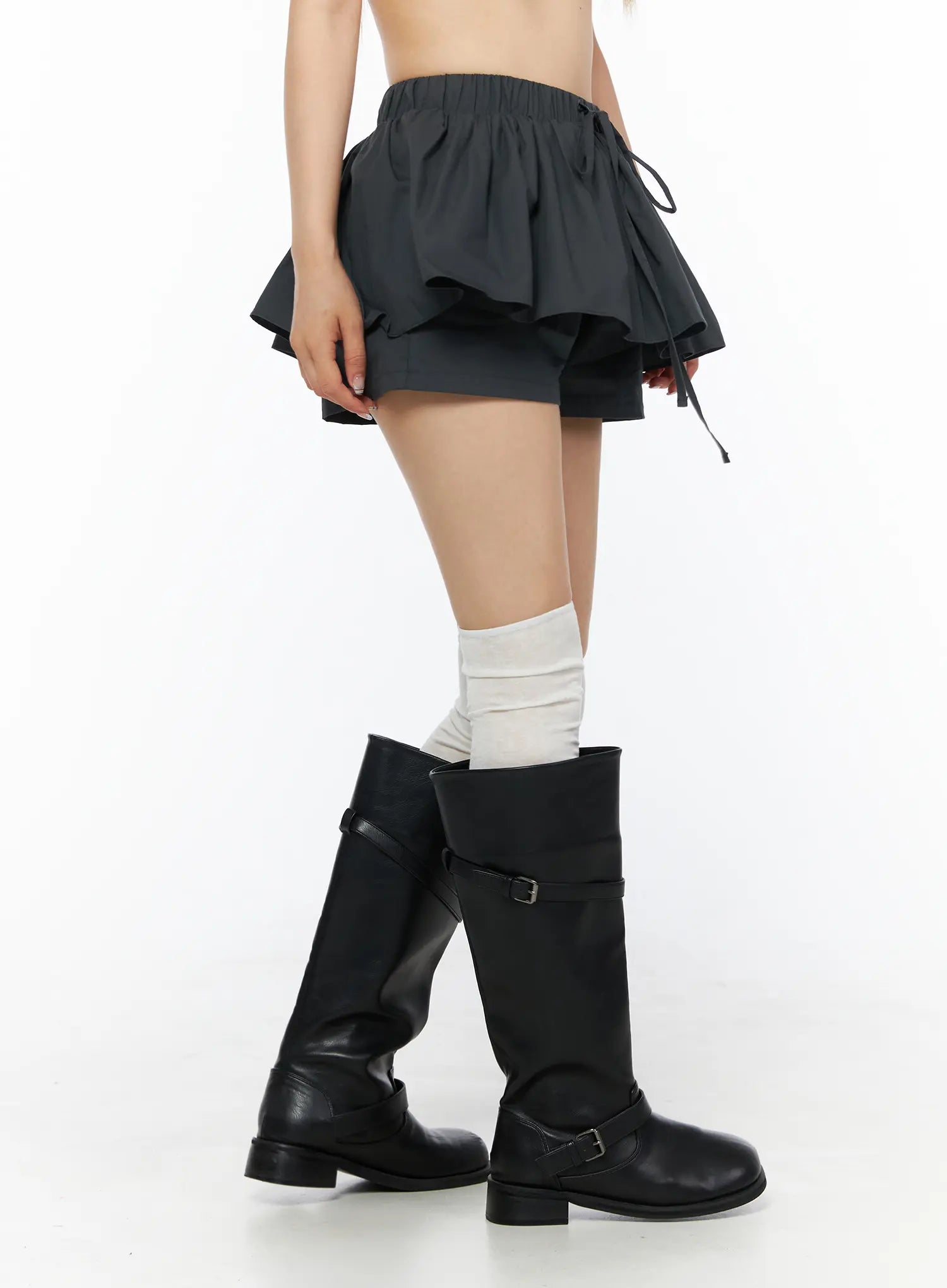 Flared Mini Skort CL501 Dark gray side view close-up on model showing layered ruffle hem, drawstring detail and inner shorts with black knee boots