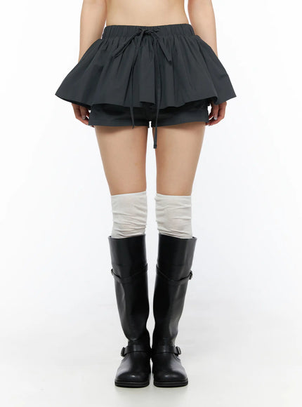 LEWKIN Flared Mini Skort CL501 Dark gray front view on model wearing black knee-high boots and white socks, layered ruffle skort with drawstring waist