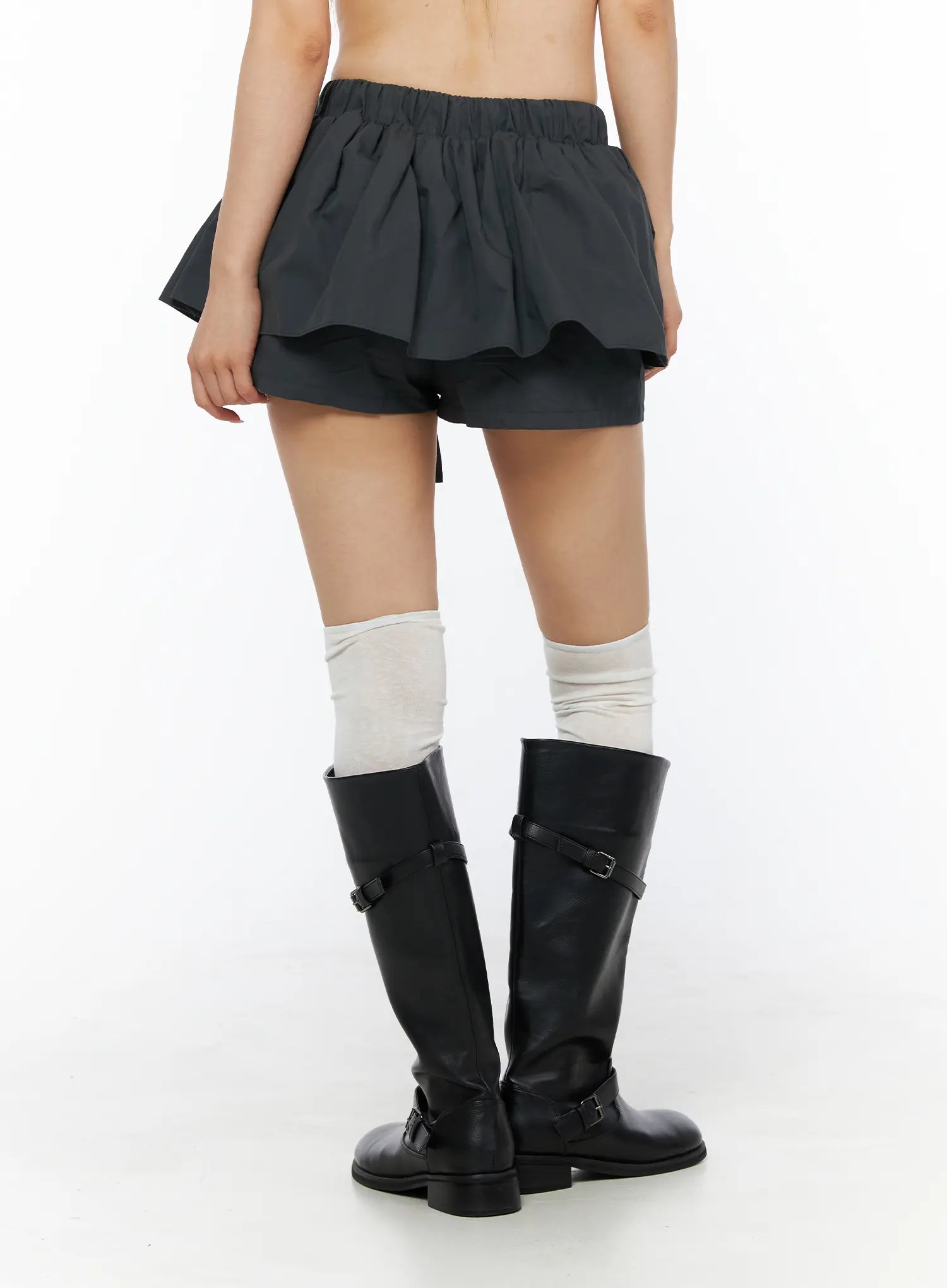 Flared Mini Skort CL501 Dark gray back view on model showing elastic waistband and double-layer ruffled skirt over built-in shorts with knee-high boots