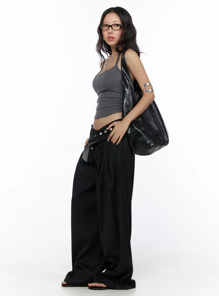 Flared Panel Sleeveless Top CL510 Dark gray three-quarter side shot on model, full-length styling with black wide-leg pants, silver arm cuff and layered necklaces